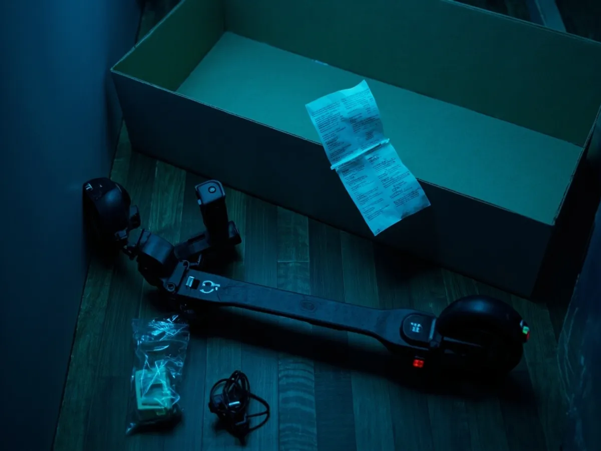 folded e-scooter with its box, receipt and charger