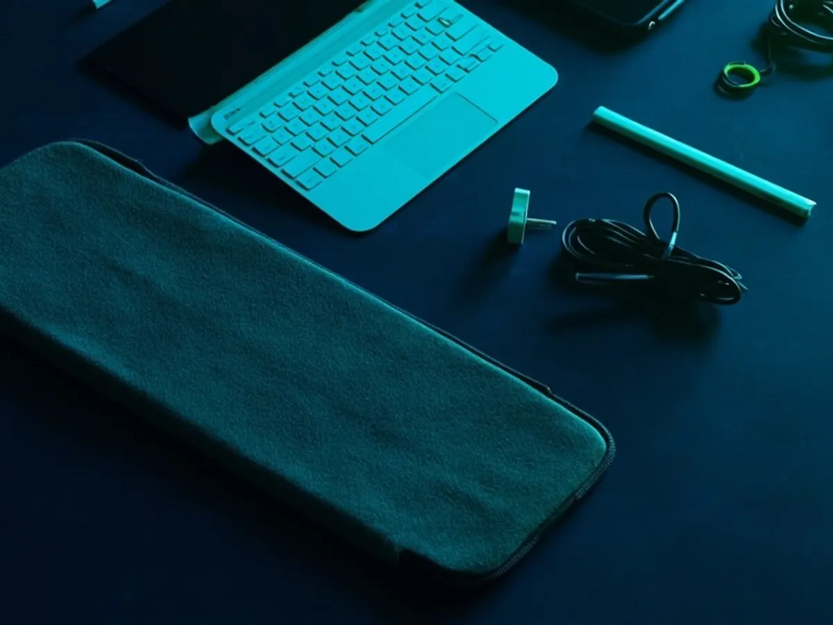tablet accessories laid out separately: stylus, keyboard case, sleeve and power adapter