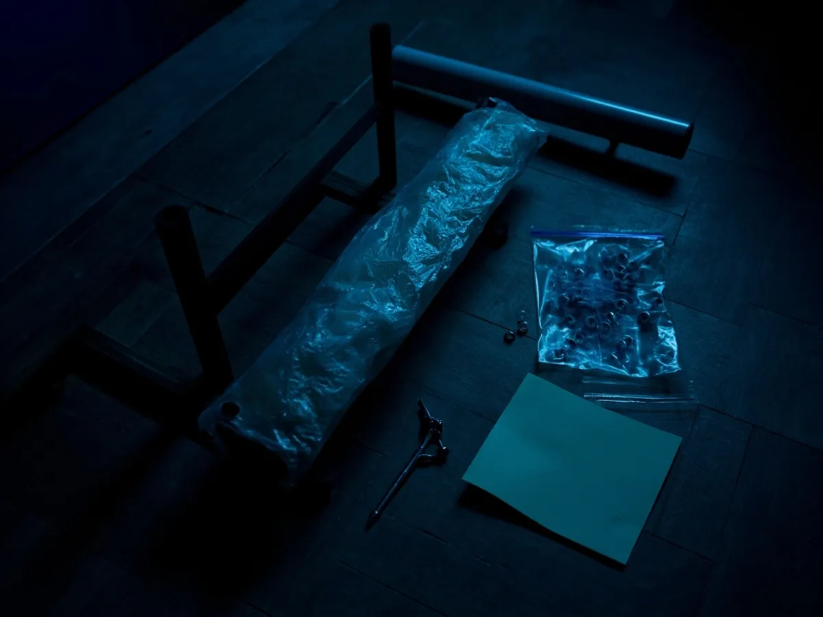 disassembled table legs wrapped in bubble wrap with bag of screws