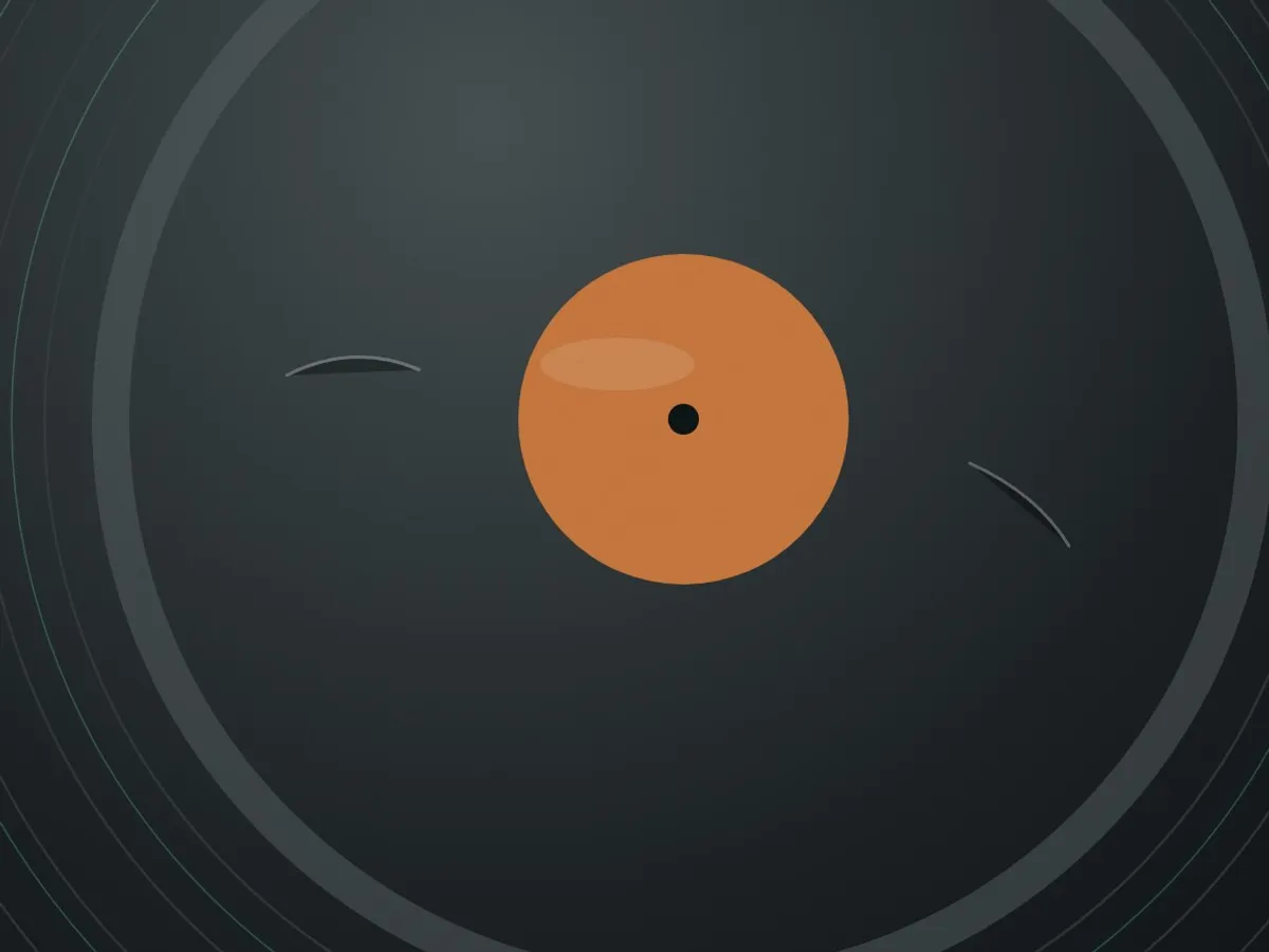 Close-up of the run-out groove area of a vinyl record catching raking light